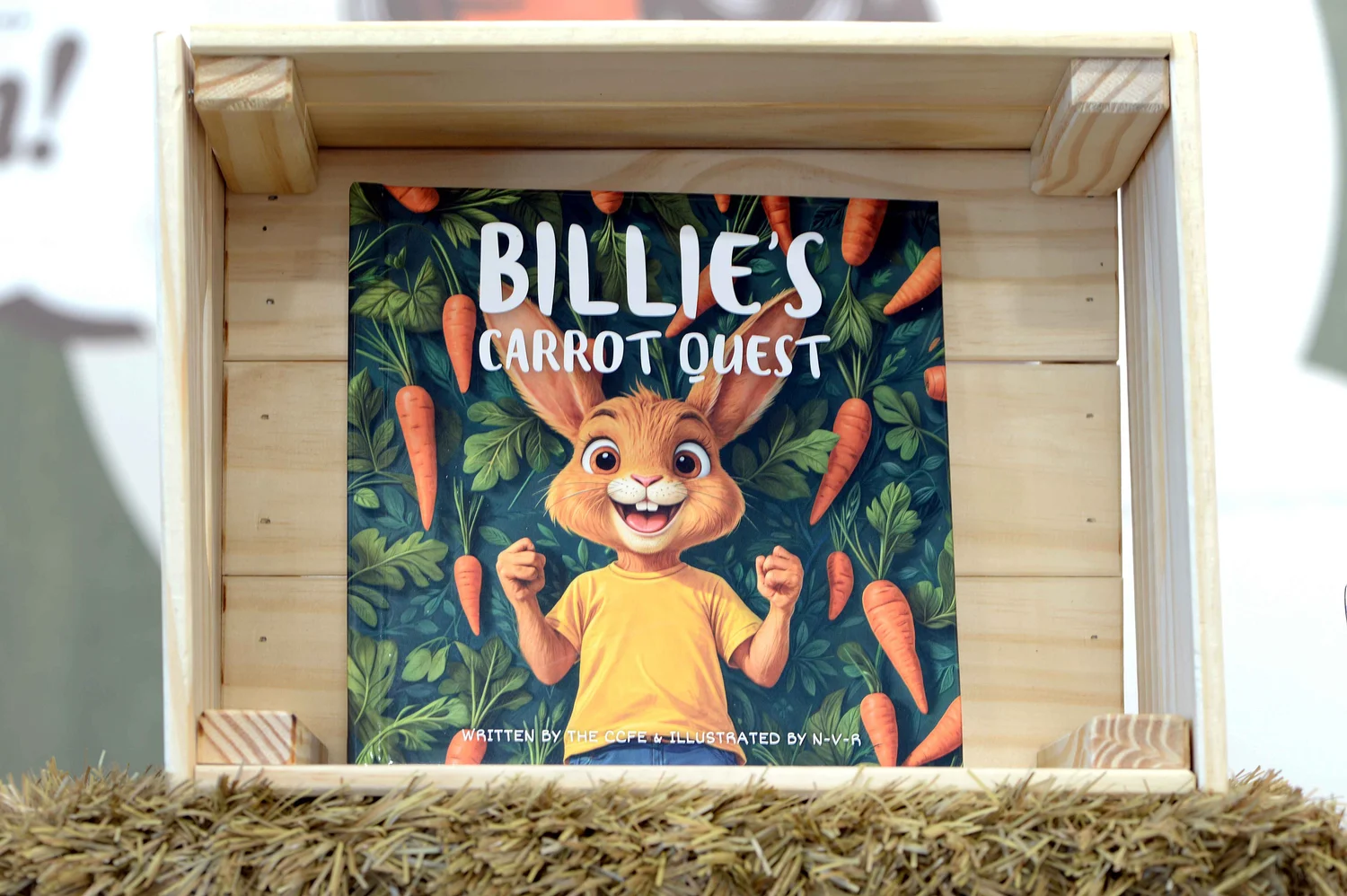 A printed copy of the book displayed in a wooden crate with straw at Flavour Harvest.